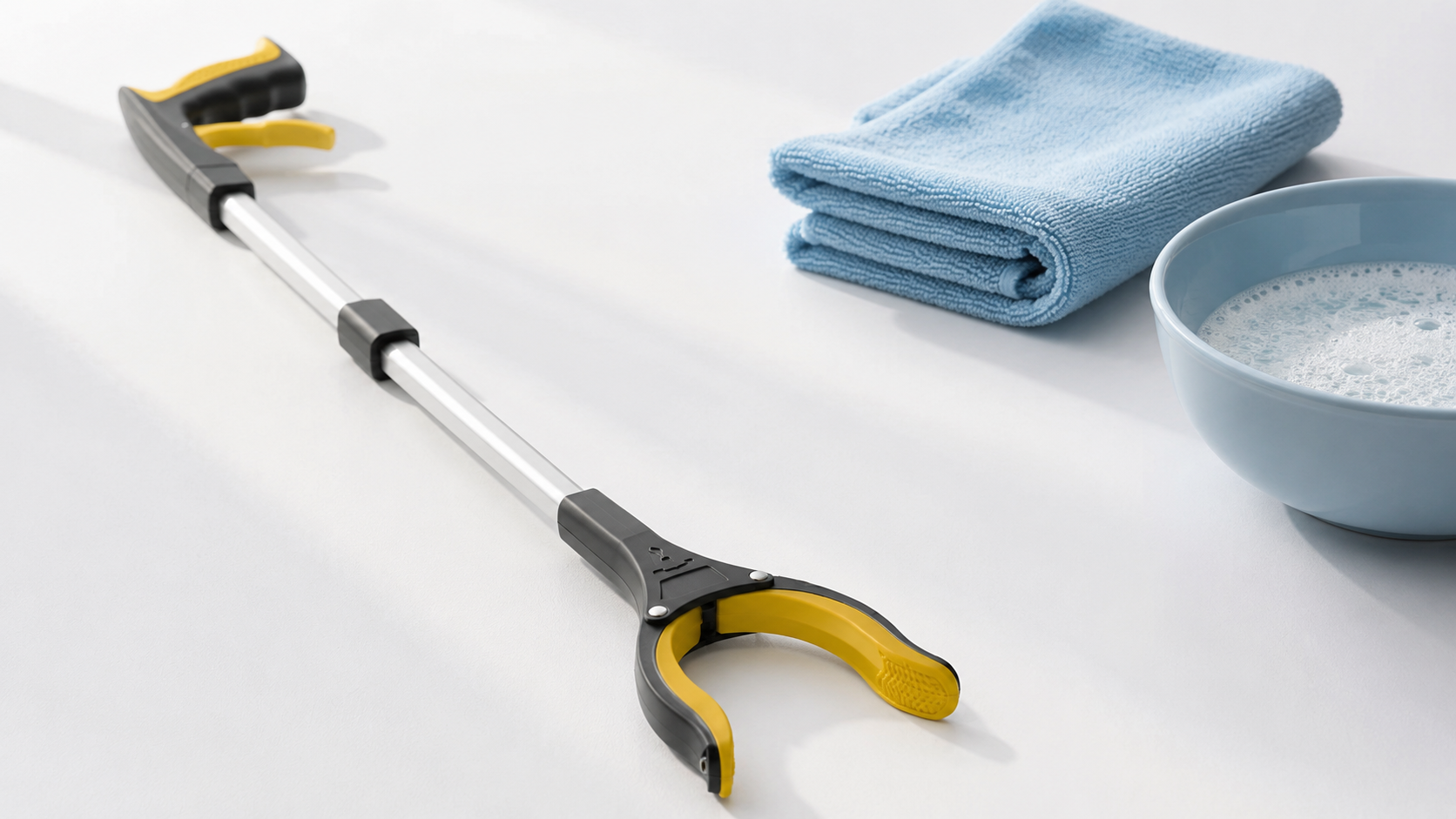 Reacher grabber tool maintenance guide — clean grabber tool with cloth and water on white surface