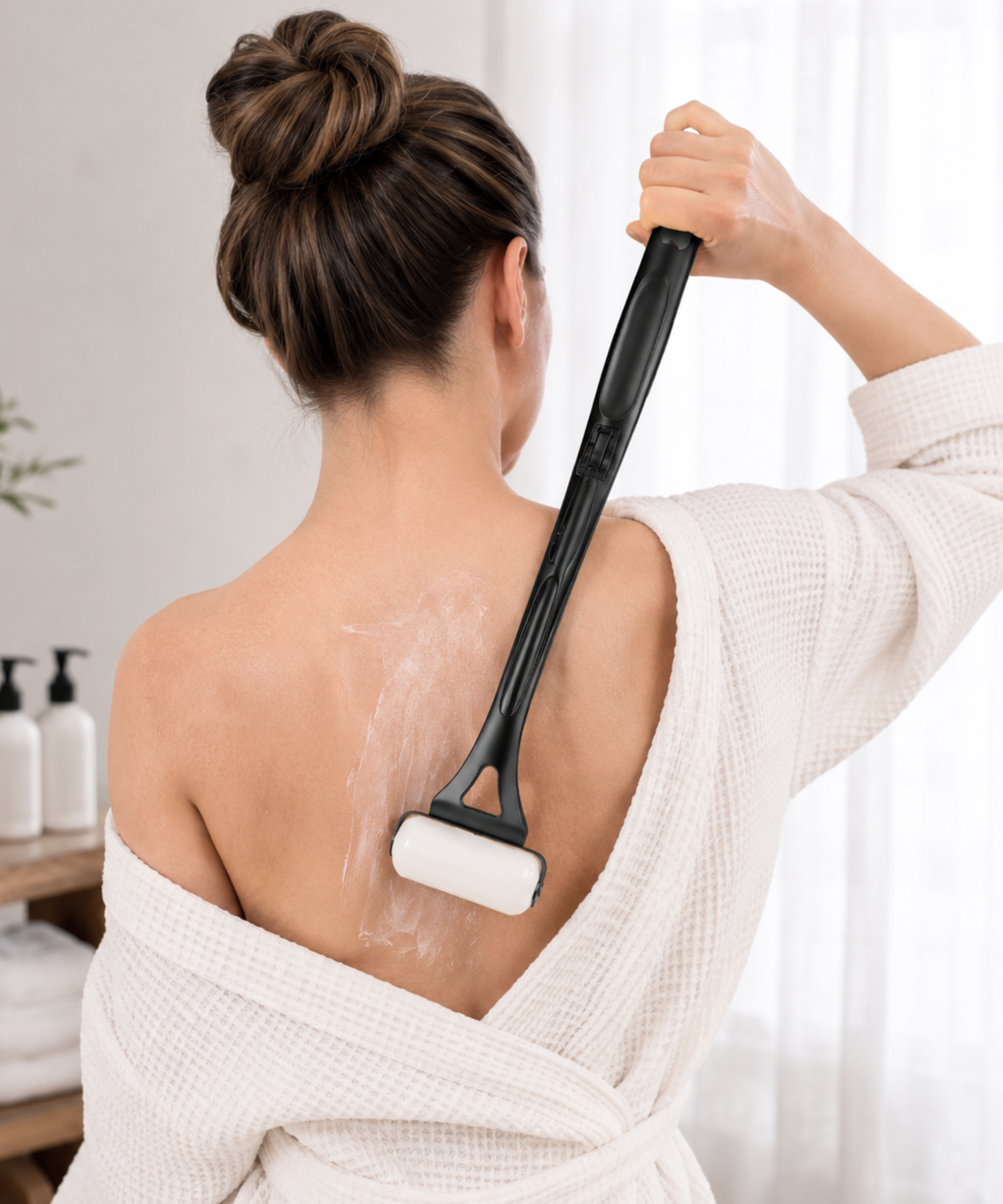 woman using a long handle applicator to put lotion on her own back without help